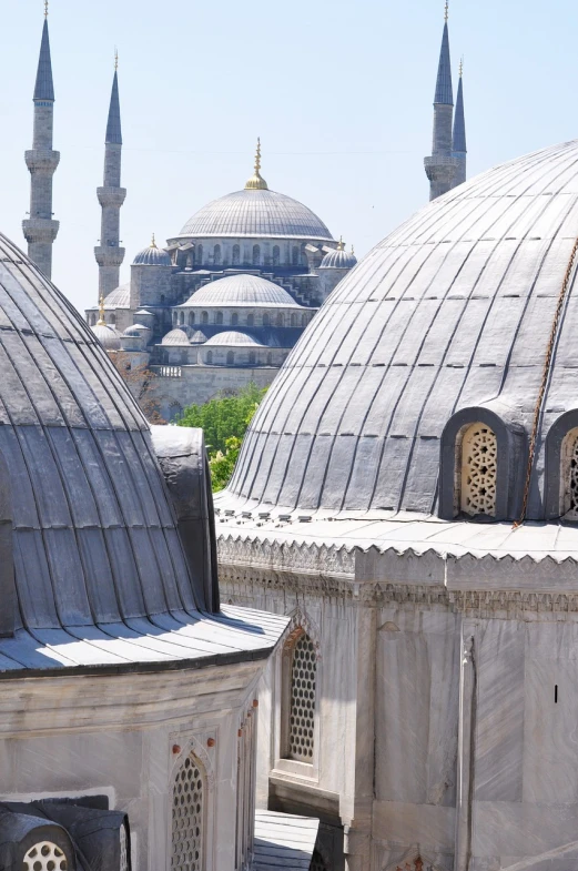 a couple of domes that are next to each other, inspired by Osman Hamdi Bey, shutterstock, closeup - view, sweeping vista, silver, wooden