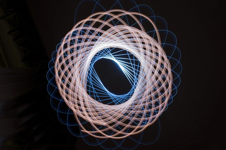 a picture of a light painting in the dark, a microscopic photo, kinetic art, orbital rings, blue and orange lighting, crown of (((white lasers))), long exposure photo