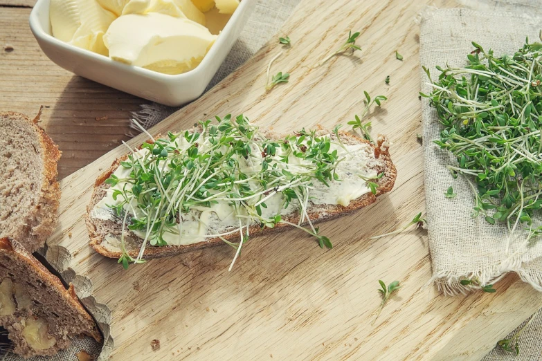 a wooden cutting board topped with bread and sprouts, shutterstock, mayonnaise, hyperedetailed photo, scandinavian style, high detail product photo