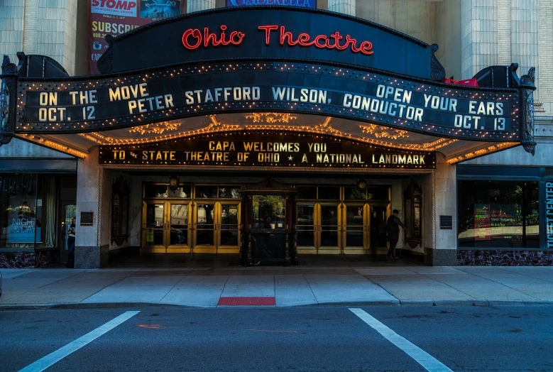 a theater marquee on the corner of a street, a photo, by William Berra, shutterstock, ohio, live concert photography, red carpet photo, pistons
