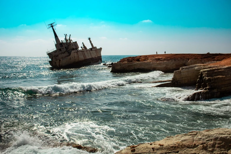 a ship sitting on top of a beach next to the ocean, a stock photo, by Richard Carline, shutterstock, surrealism, israel, crumbling ruins, an eerie whirlpool, shot on leica sl2