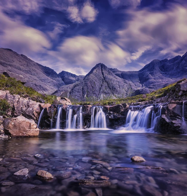 an image of a waterfall in the mountains, by Alexander Robertson, shutterstock, skye meaker, epic mountains in the background, tonemapped, deep clear pools of water