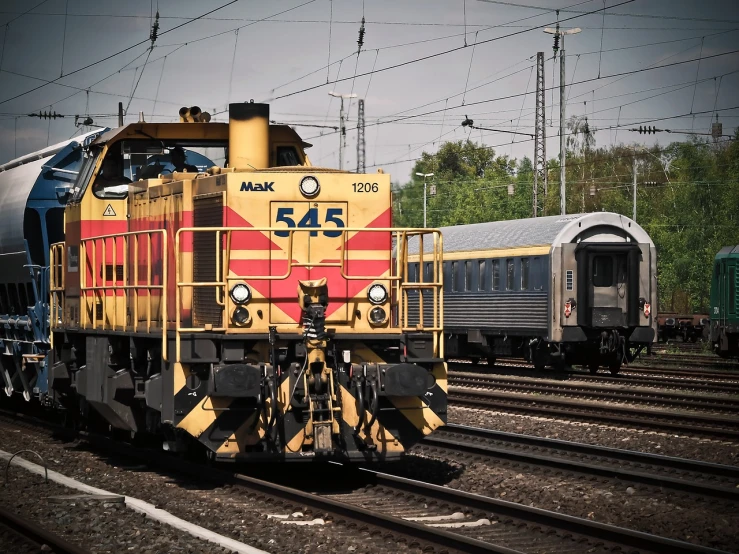 a train traveling down train tracks next to a forest, by Thomas Häfner, shutterstock, graffiti, diesel engine, mule, budapest, terminal