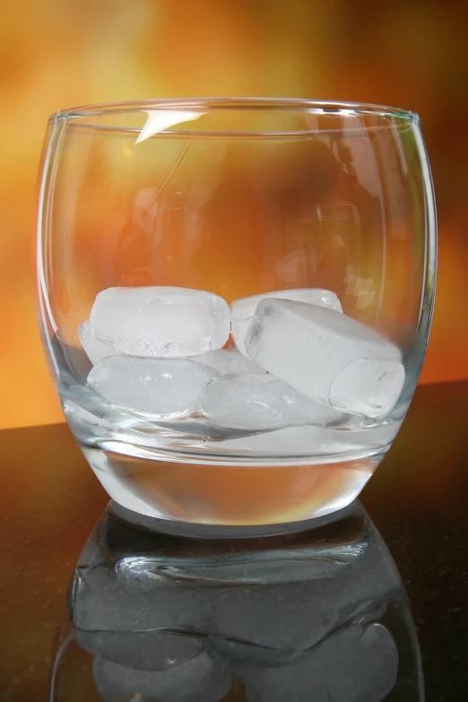 a glass filled with ice sitting on top of a table, crystal cubism, istockphoto, 2000s photo, close-up product photo, glazed