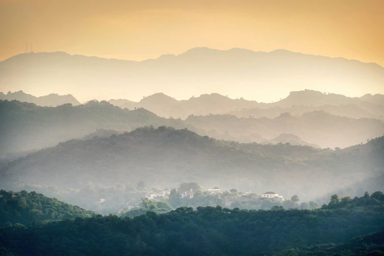 a plane flying over a lush green hillside, a tilt shift photo, by Alexander Robertson, sumatraism, pagodas on hills, hazy morning foggy, mexico, sunfaded