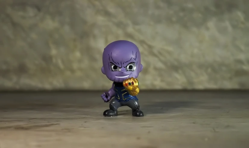 a close up of a toy figure on a table, by Hiroyuki Tajima, pexels, thanos, chibi proportions, full body shot 4k, evil pose