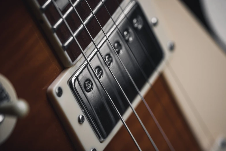 a black and white photo of an electric guitar, a macro photograph, shutterstock, caramel, close - up on detailed, metal body, 7 0 s photo