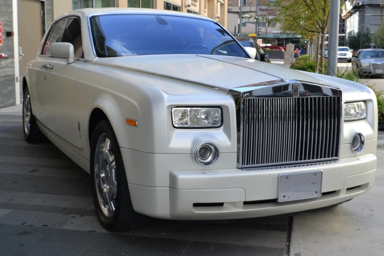 a white rolls royce parked in front of a building, by Alexander Robertson, flickr, renaissance, new york, trimmed with a white stripe, silver，ivory, very expensive
