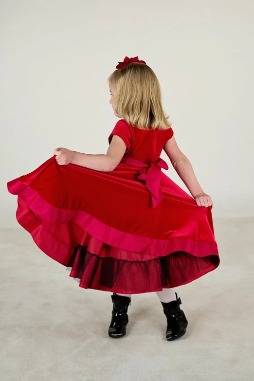 a little girl wearing a red dress and black boots, inspired by Margaret Brundage, tumblr, ombre velvet gown, double layer fold over hem, pink and red color scheme, from back