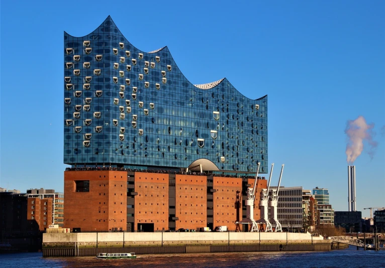 a large building next to a body of water, by Juergen von Huendeberg, shutterstock, modernism, megastructure in the background, ham, mane, set photo