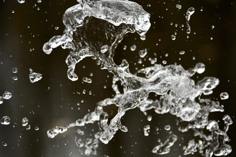 a close up of water coming out of a faucet, by Jan Rustem, water particles, clear detailed view, black splashes, flowing forms