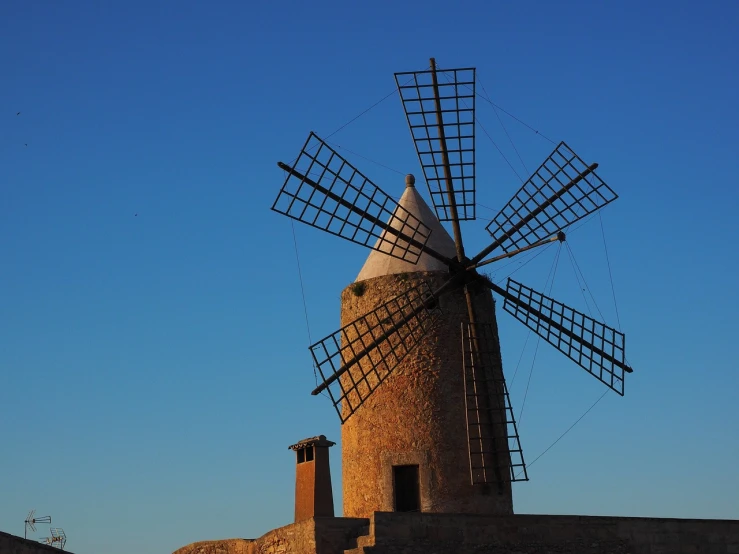 a windmill on a hill with a blue sky in the background, a picture, by Marcello Bacciarelli, baroque, back lit, photo photo, zurbaran, very beautiful photo