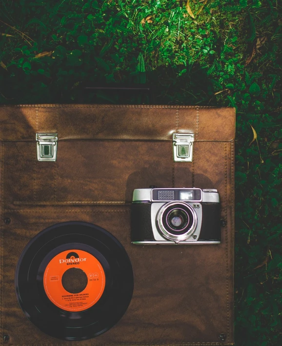 a record sitting on top of a piece of luggage, a picture, inspired by William Harnett, pexels contest winner, forest picnic, hasselblad camera, stock photograph, vintage - w 1 0 2 4