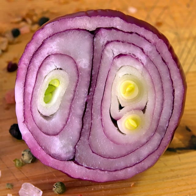 a close up of a sliced onion on a cutting board, a picture, by Jan Rustem, renaissance, purple magic, happy face, highly detailed product photo, salad