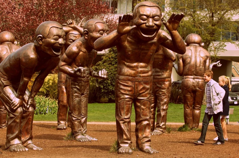 a group of people standing around a bronze statue, inspired by Yue Minjun, flickr, too many teeth, whistler, garden, oversaturated