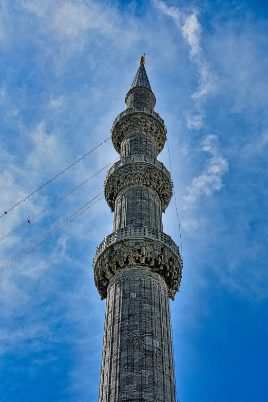 a tall tower with a clock on top of it, by Nevin Çokay, hurufiyya, hdr detail, three masts, lead - covered spire, 3/4 view from below