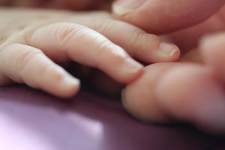 a close up of a person holding a baby's hand, by Julian Allen, digital art, typing on laptop, closeup 4k, seams, phone photo