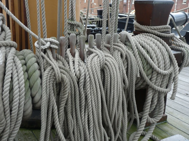 a pile of rope sitting on top of a wooden dock, by Edward Corbett, flickr, renaissance, sailing ships, grey, [ closeup ]!!, ship interior