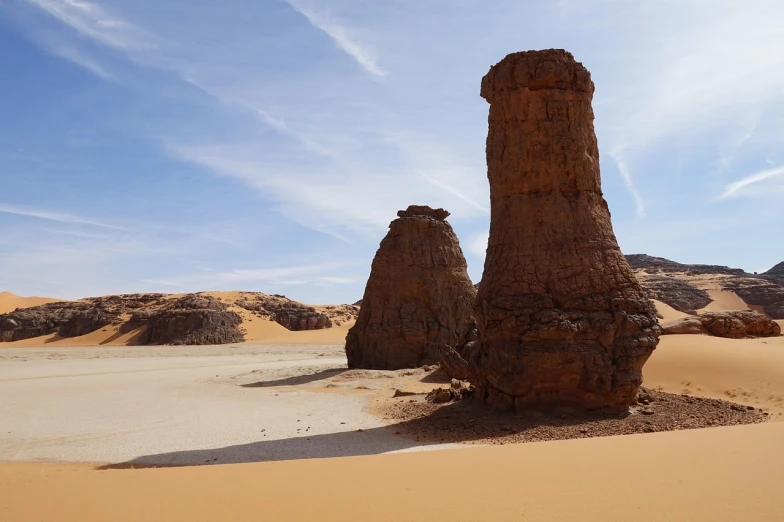 a rock formation in the middle of a desert, les nabis, two giant towers, paul atreides, chambliss giobbi, sandy beach