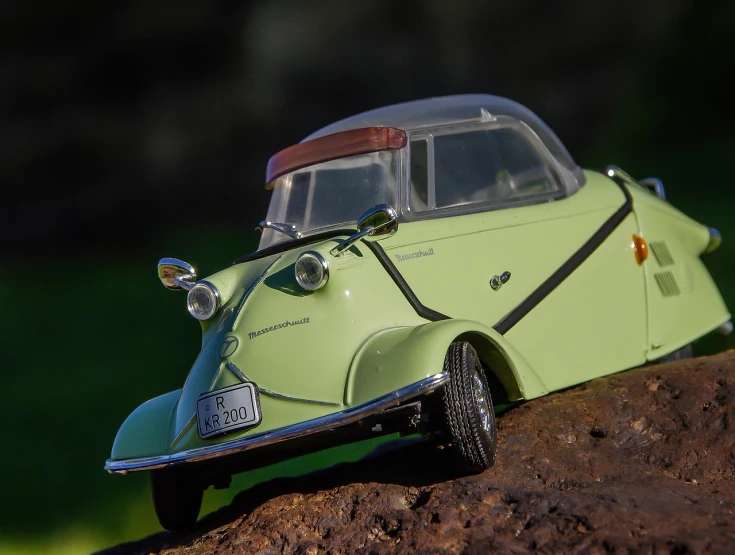 a toy car sitting on top of a rock, inspired by Oskar Lüthy, tumblr, photorealism, avocado car, kama russian electrocar, roadster, [ closeup ]!!