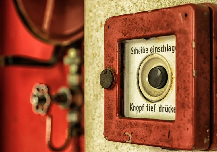 a red fire hydrant mounted to the side of a wall, a stock photo, by Hans Schwarz, pexels, arbeitsrat für kunst, old experimentation cabinet, button potenciometers, in an elevator, subtitles