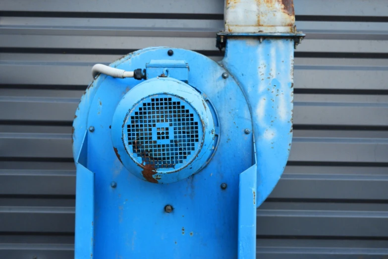 a blue fire hydrant on the side of a building, a portrait, hurufiyya, waste processing machinery, fans, close up photo, portlet photo
