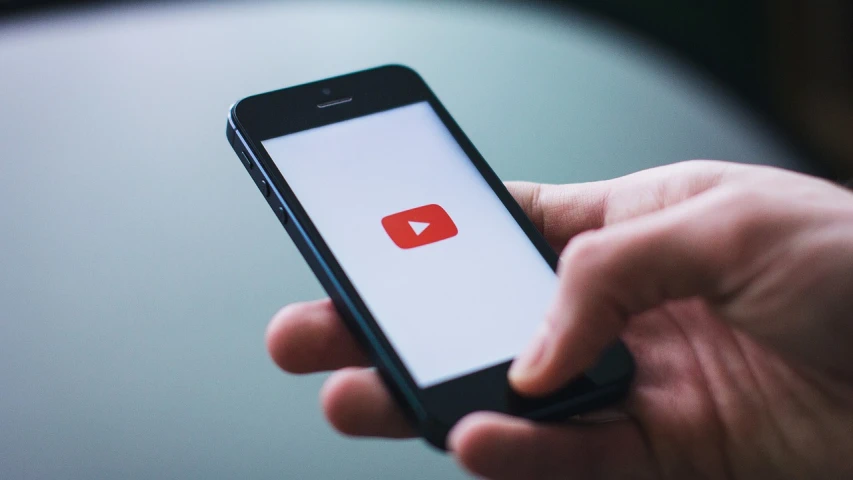 a close up of a person holding a cell phone, a picture, happening, youtube video, simple stylized, subtle, ios