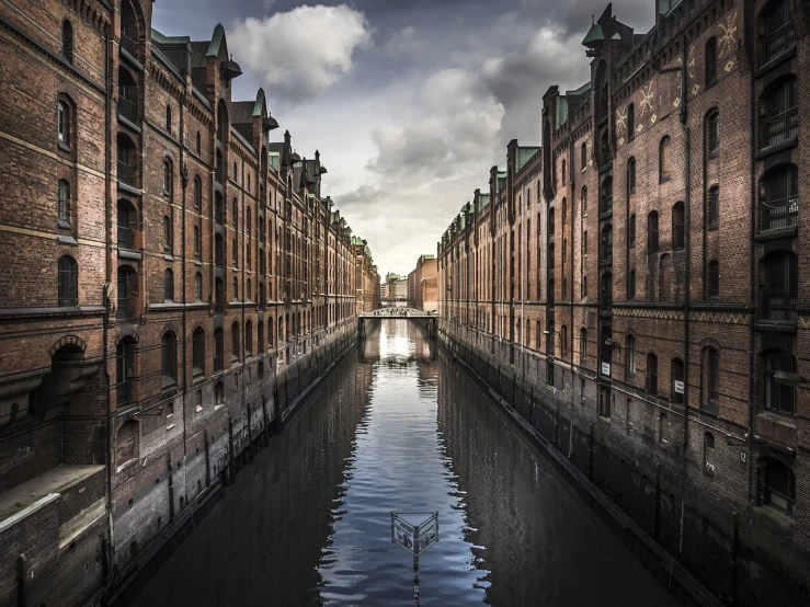 a canal filled with lots of water next to tall buildings, a detailed matte painting, by Dirk Helmbreker, pexels contest winner, minimalism, warehouses, germany. wide shot, intense dramatic hdr, stock photo