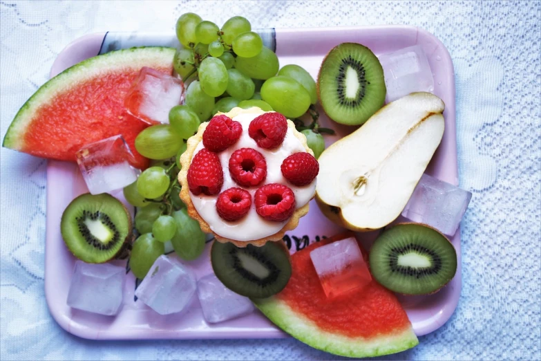 a close up of a plate of fruit on a table, inspired by Henriette Grindat, pexels, pink white and green, colourful cupcake, lumi, summer vibrance