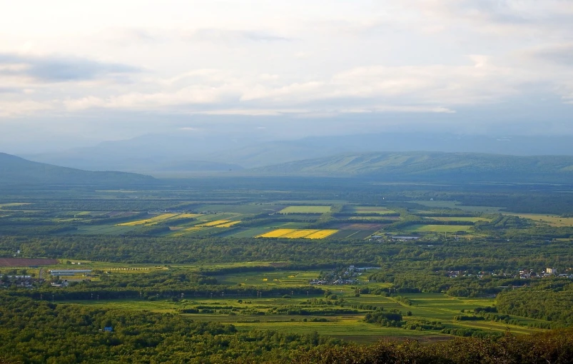 a view of the countryside from the top of a hill, by Erwin Bowien, flickr, quebec, solar field plains, mountain valley, biggish nose