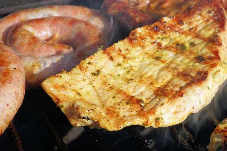 a close up of meat and sausages cooking on a grill, a photo, figuration libre, high res photo, fish tail, istockphoto, cheesy