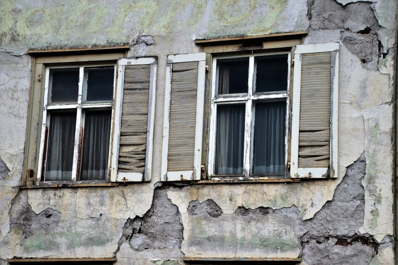 a couple of windows sitting on the side of a building, by Ferenc Joachim, flickr, damaged city, img _ 9 7 5. raw, terrified, shutters