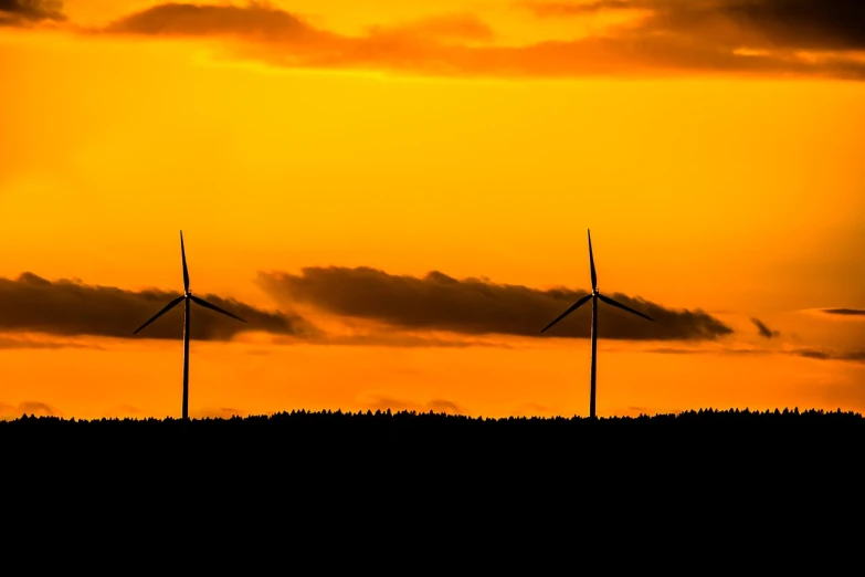 a group of wind turbines sitting on top of a hill, a photo, by Thomas Häfner, pexels contest winner, precisionism, sunset panorama, silhouette!!!, new mexico with a yellow filter, 200mm wide shot