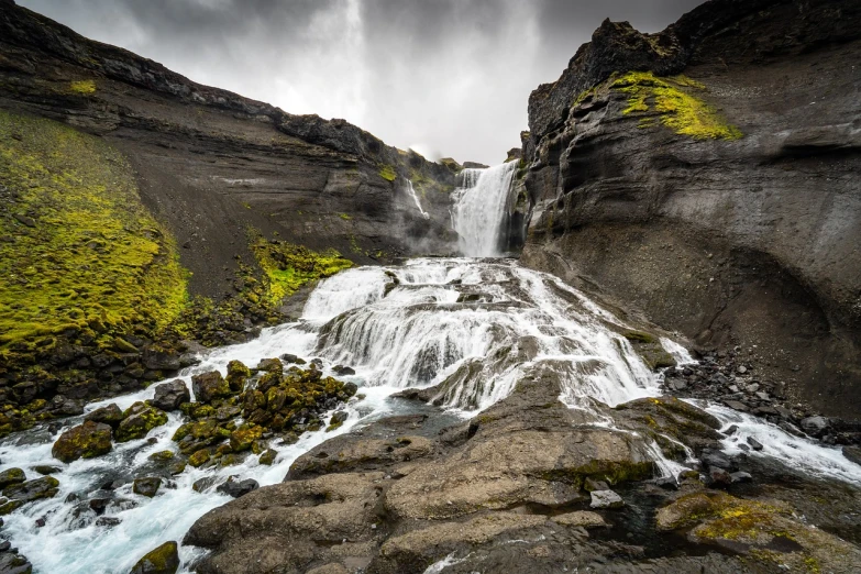 a waterfall in the middle of a rocky area, a picture, by Alexander Robertson, shutterstock, iceland landscape photography, amazing depth, sandfalls, detailed wide shot