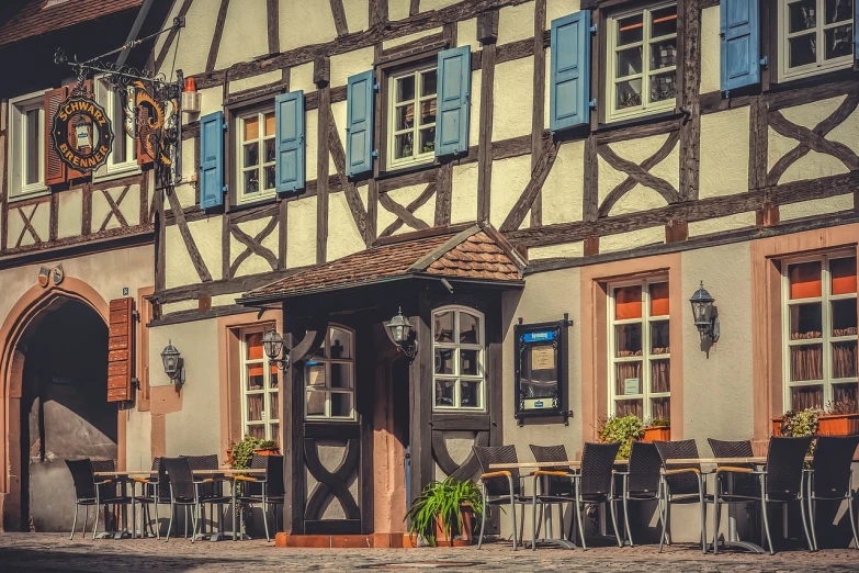 a building with tables and chairs in front of it, by Thomas Häfner, shutterstock, a multidimensional cozy tavern, bizzaro, ((oversaturated)), black forest