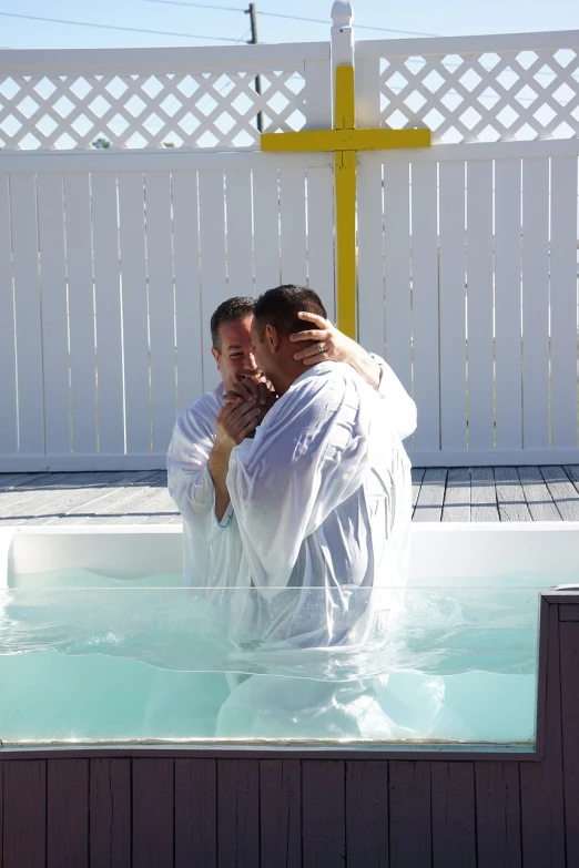 two men hugging each other in a hot tub, by Joy Garnett, happening, baptism, florida, installation, white