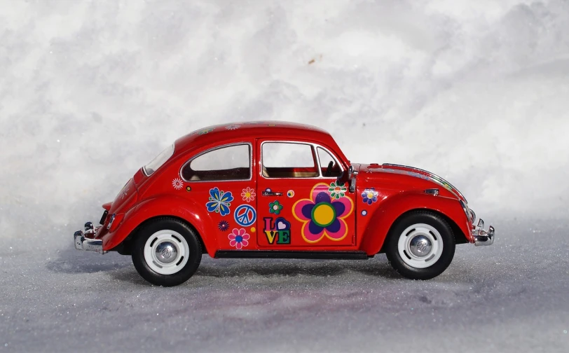 a red toy car sitting on top of a snow covered ground, a photo, inspired by Murakami, toyism, 1960s flower power hippy, side profile view, beetles, -w 1024