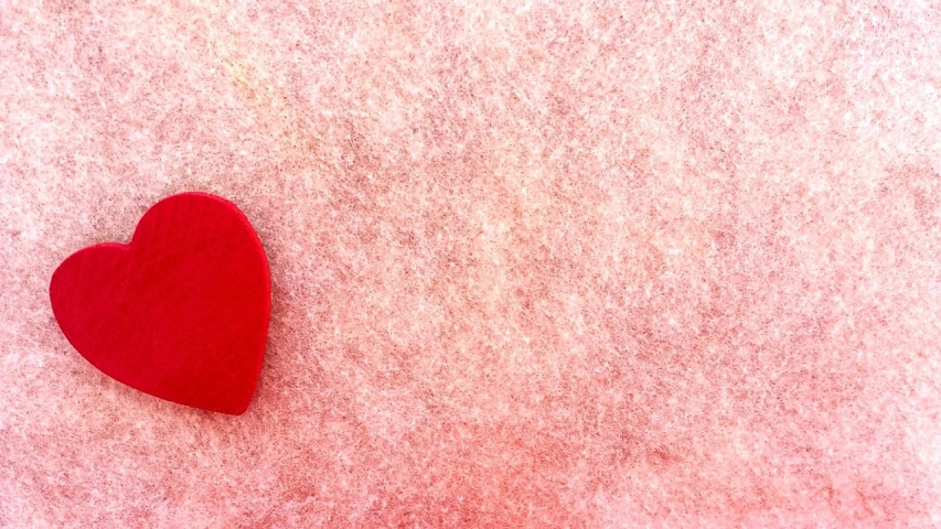 a red heart sitting on top of a snow covered ground, an album cover, trending on pixabay, postminimalism, soft red texture, website banner, covered with pink marzipan, felt!!! texture