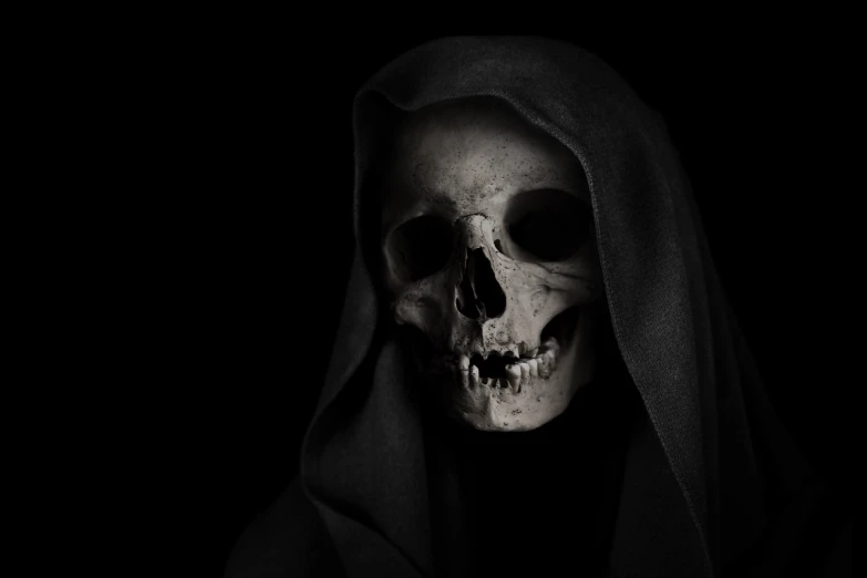 a black and white photo of a skull in a hoodedie, by Bernardino Mei, pexels contest winner, single scary female vampire nun, portrait of grim reaper, stock photo, rick baker