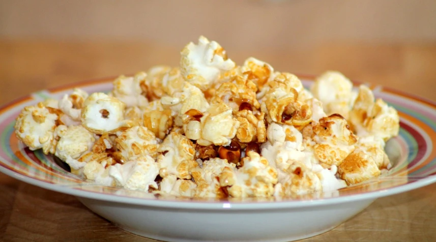 a bowl of popcorn sitting on top of a wooden table, by Ella Guru, hurufiyya, square, 4k -4, dessert, lightbox