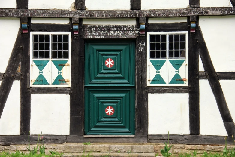 a black and white building with a green door, by Dietmar Damerau, flickr, folk art, lower saxony, medieval, closeup photo, geometrical masterpiece