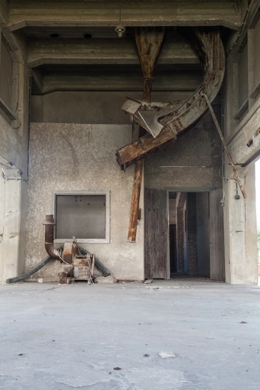 a fire hydrant sitting inside of a building next to a fire hydrant, brutalism, collapsed ceiling, theater stage, wooden supports, grey warehouse background