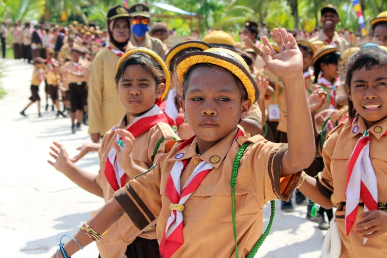 a group of young girls standing next to each other, shutterstock, sumatraism, scout boy, triumphant pose, caracter with brown hat, inauguration