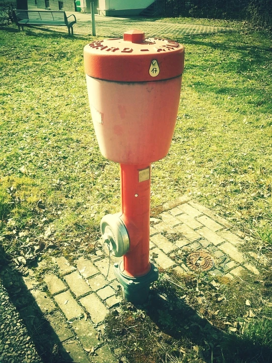 a red fire hydrant sitting on top of a grass covered field, a photo, by Stefan Gierowski, flickr, trash can, retro device, switch, an upside down urinal