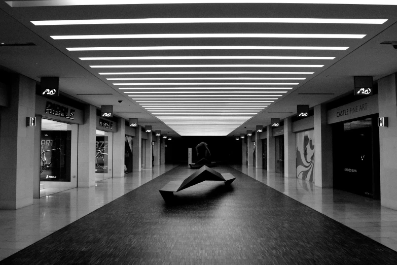 a black and white photo of a person with an umbrella, inspired by Ryoji Ikeda, minimalism, inside a brutalist space ship, marble!! (eos 5ds r, in a mall, aleksander rostov