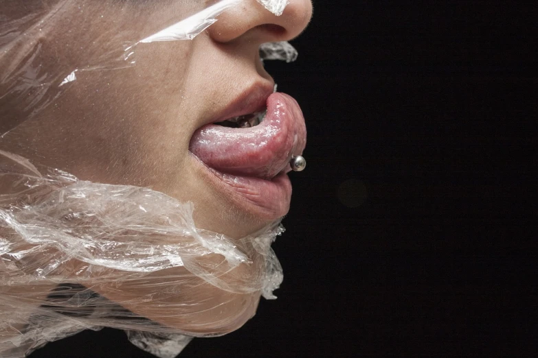 a close up of a person sticking their tongue out, by Jan Rustem, flickr, hyperrealism, plastic wrap, strangled with rope, female gigachad, low-key