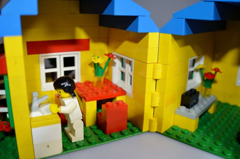 a close up of a toy house made out of legos, a picture, by Thomas Kluge, flickr, window open, yellow theme, open plan, little cottage