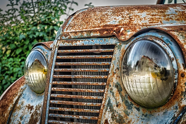 a close up of the front of an old truck, a portrait, by Richard Carline, pixabay, rusty cars!!, car lights, eyes!, photorealism. trending on flickr