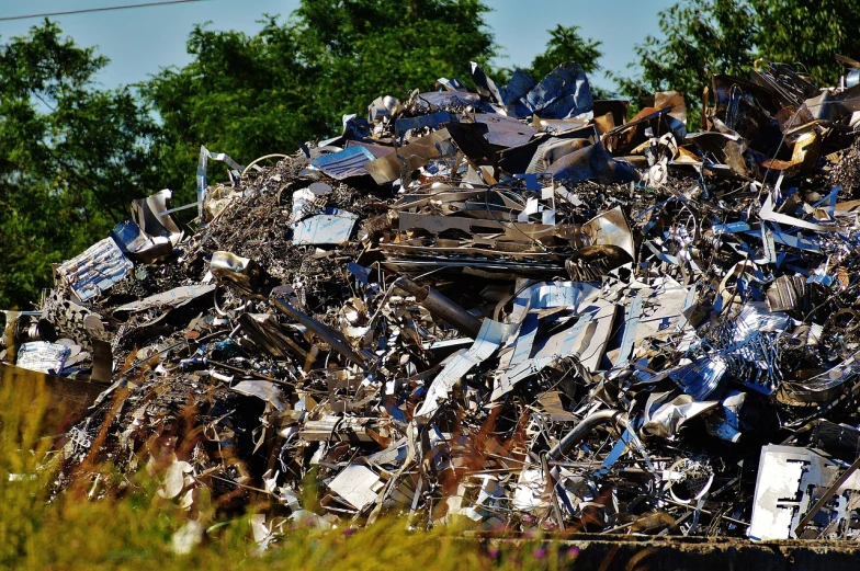 a pile of scrap metal with trees in the background, a photo, from wheaton illinois, complex layered composition!!, taken on a nikon, 4 2 0 0 k