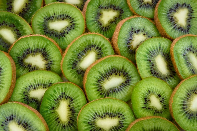 a pile of sliced kiwis sitting on top of each other, a stock photo, pexels, hurufiyya, istockphoto, kaleidoscopic, north island brown kiwi, closeup!!!!!!